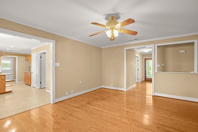 spare room with ceiling fan, ornamental molding, and light hardwood / wood-style flooring