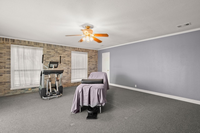 bedroom with dark colored carpet, crown molding, brick wall, and ceiling fan