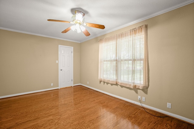 empty room with ceiling fan, ornamental molding, and wood-type flooring