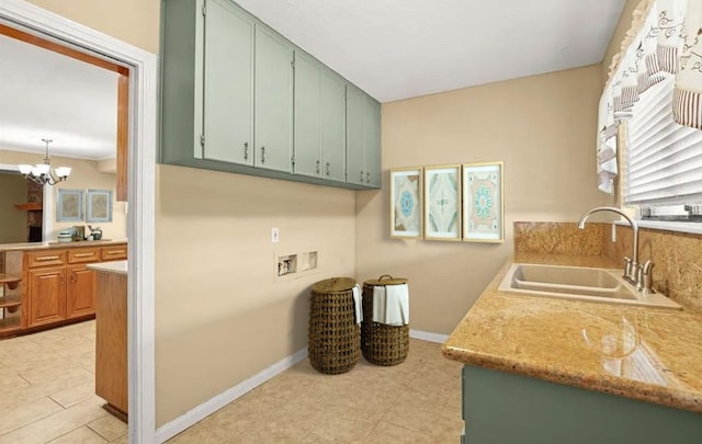 8712 Cele Rd Unit 1, Manor, TX 78653 - washroom with washer hookup, a chandelier, baseboards, and cabinet space
