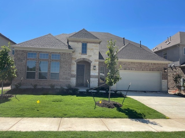 view of front of home with a garage and a front yard