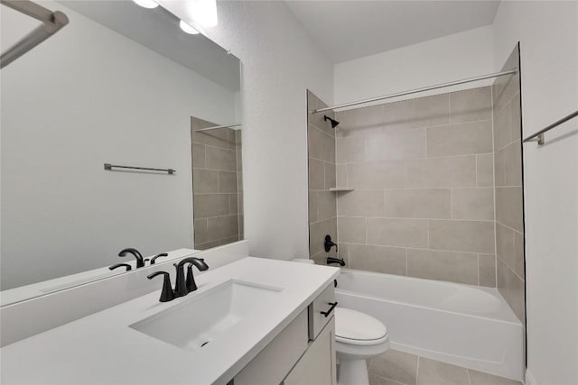 bathroom featuring tile patterned floors, shower / washtub combination, toilet, and vanity