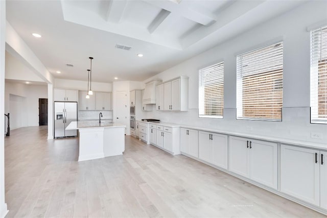 kitchen featuring visible vents, a healthy amount of sunlight, light wood-type flooring, light countertops, and stainless steel appliances