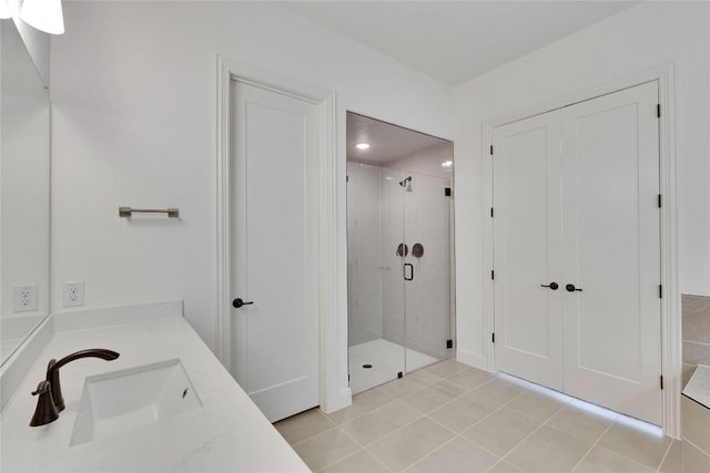 bathroom with vanity, a shower stall, and tile patterned flooring