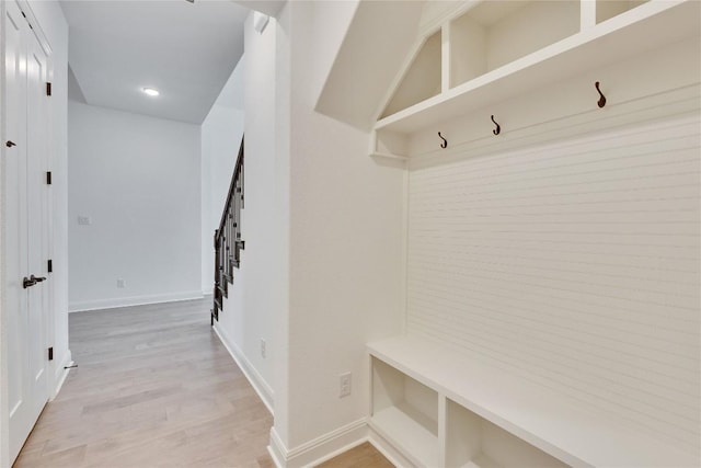 mudroom with recessed lighting, baseboards, and light wood finished floors