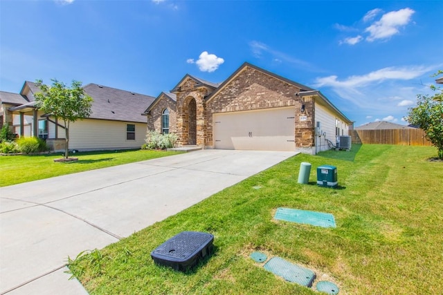 view of front of property with central AC unit, fence, a garage, driveway, and a front lawn