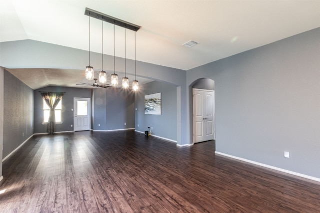 empty room with vaulted ceiling, ceiling fan, and dark wood-type flooring