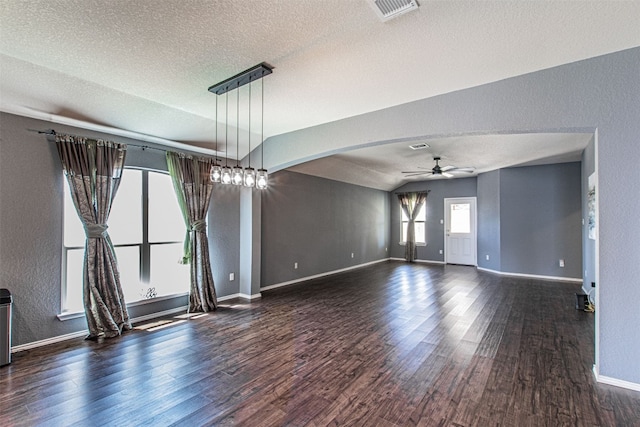 unfurnished room featuring dark hardwood / wood-style flooring, a textured ceiling, ceiling fan, and lofted ceiling