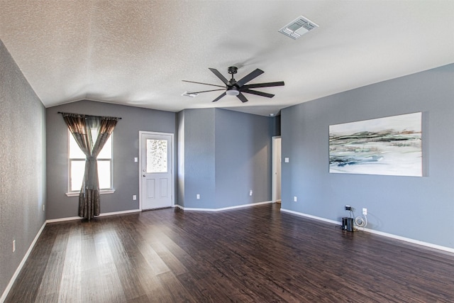 interior space with a textured ceiling, dark hardwood / wood-style floors, ceiling fan, and lofted ceiling