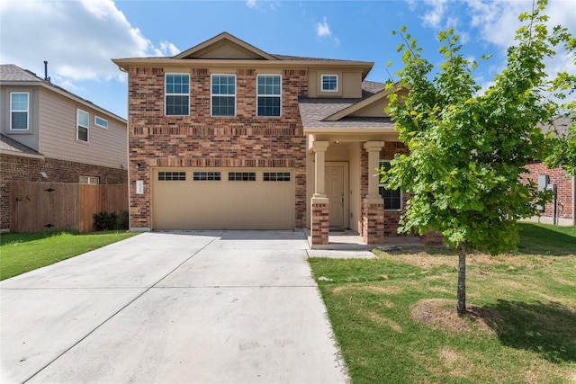 view of front of property with a garage and a front lawn