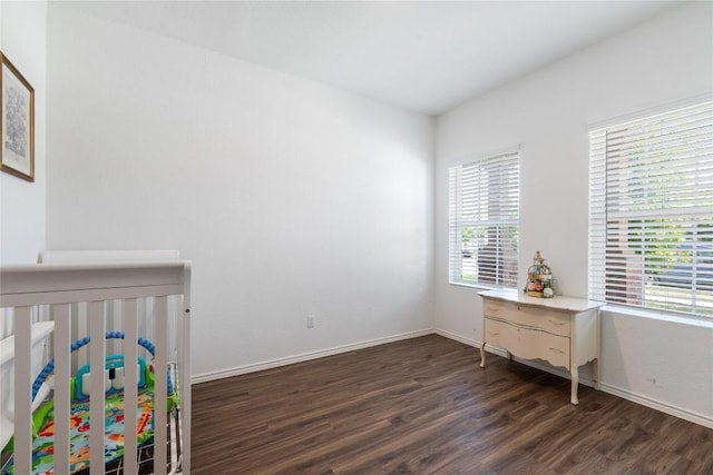 bedroom with dark hardwood / wood-style floors