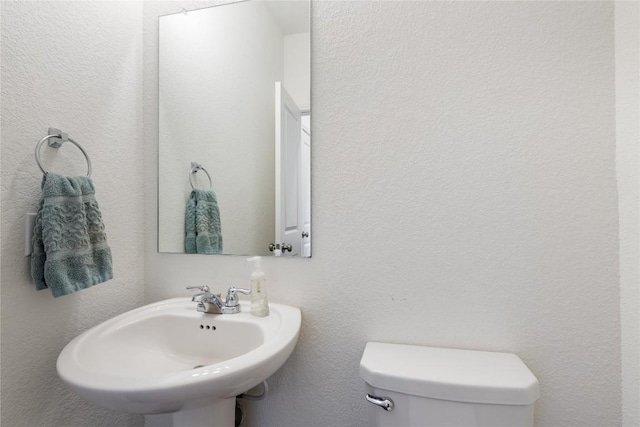 bathroom featuring toilet and sink