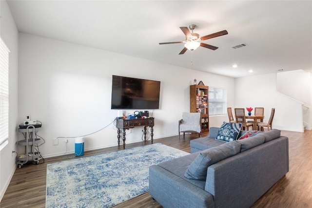 living room with hardwood / wood-style flooring and ceiling fan