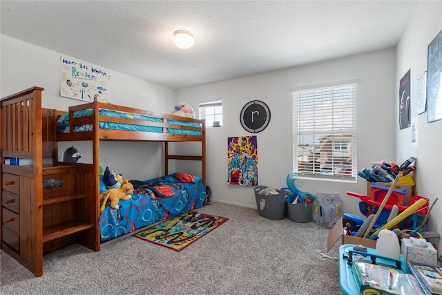 bedroom featuring carpet and a textured ceiling