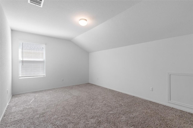 bonus room featuring carpet floors and lofted ceiling