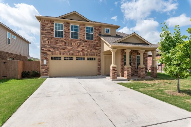 view of front of home with covered porch, a garage, and a front lawn