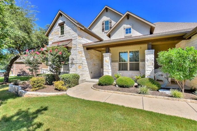 view of front of house featuring a front lawn and covered porch