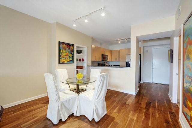 dining area featuring dark hardwood / wood-style flooring