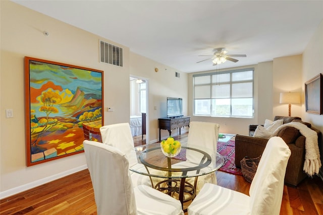 dining area featuring hardwood / wood-style floors and ceiling fan