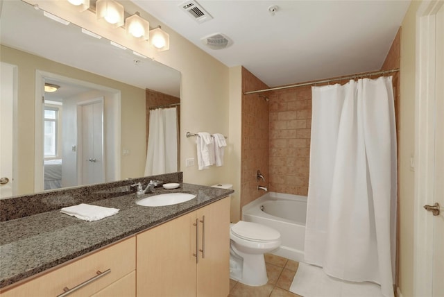 full bathroom featuring tile patterned floors, toilet, vanity, and shower / bath combo