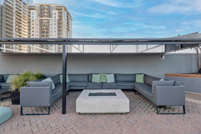 view of patio featuring an outdoor living space with a fire pit