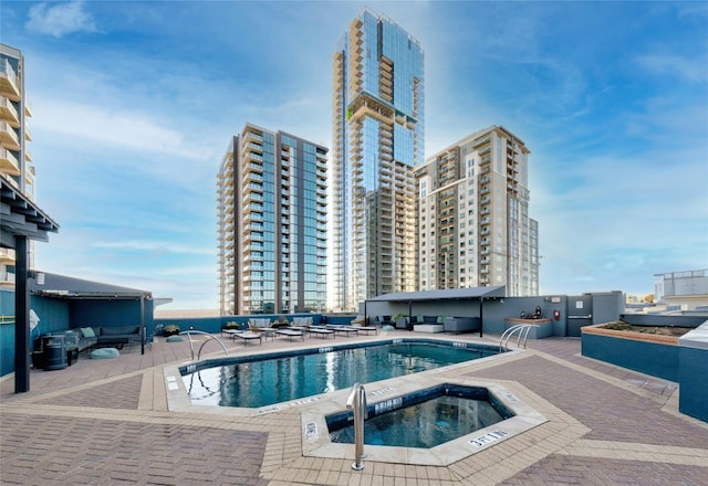 view of pool featuring a patio and a community hot tub