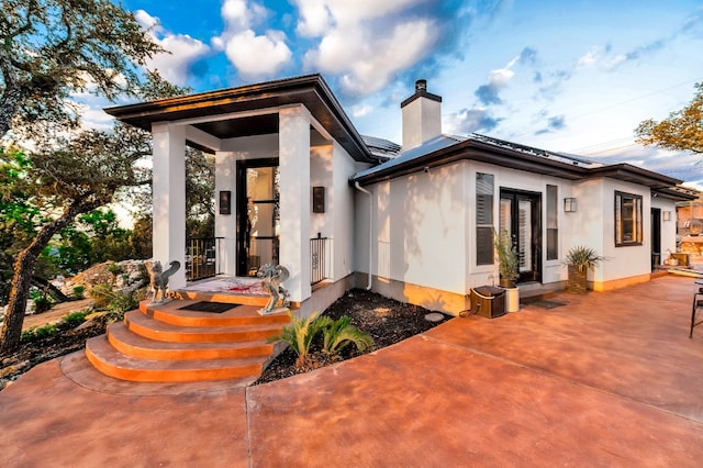 rear view of property featuring a patio and french doors