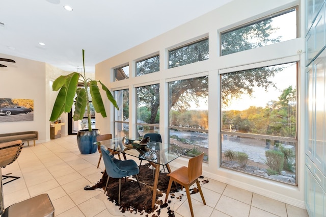 tiled dining space featuring ceiling fan and a wealth of natural light