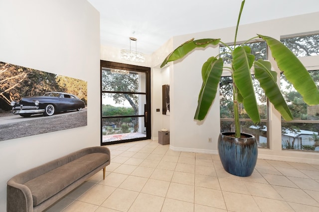 tiled entrance foyer with an inviting chandelier