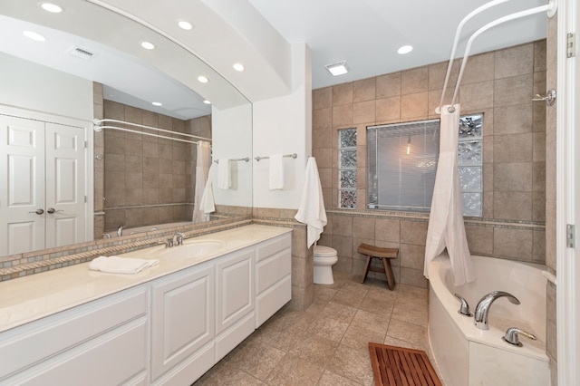 bathroom with vanity, tile walls, toilet, and tile patterned floors