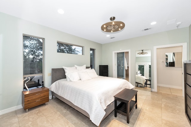 bedroom featuring light tile patterned flooring and connected bathroom