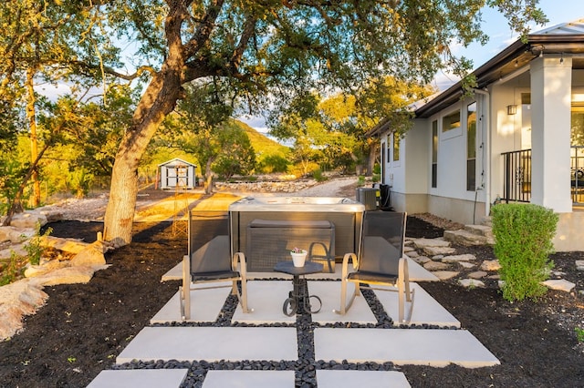 view of patio / terrace featuring a storage unit and central AC