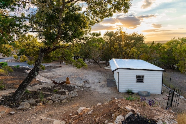 yard at dusk with an outbuilding