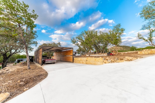 view of side of home with a carport