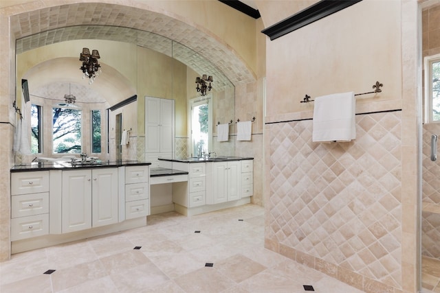 bathroom featuring tile patterned floors, lofted ceiling, ceiling fan, and double sink vanity