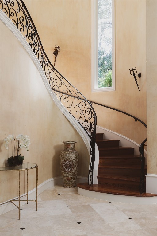 staircase with tile patterned floors