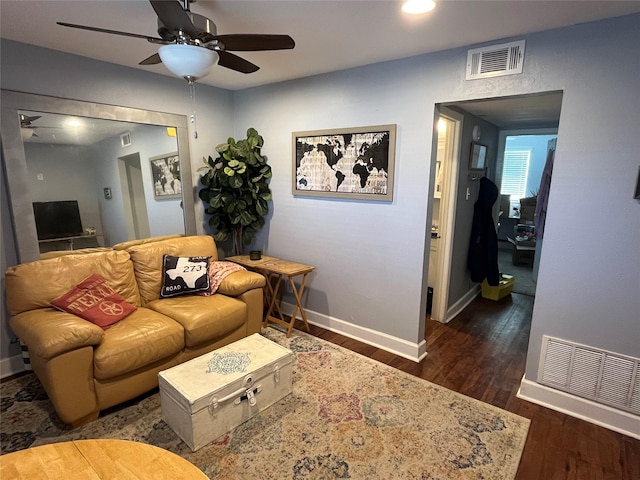 living room featuring ceiling fan and dark hardwood / wood-style floors