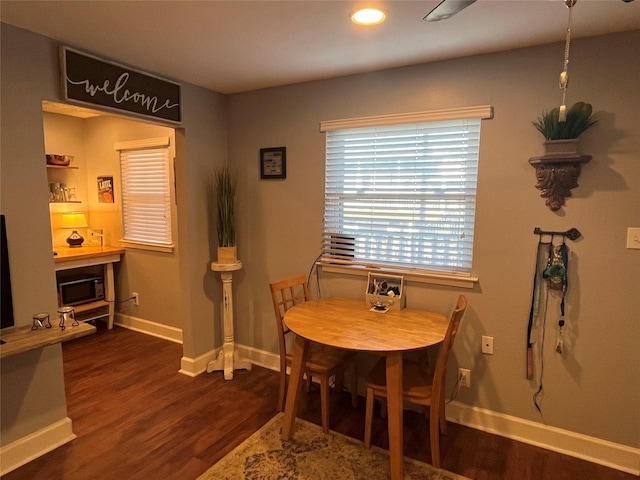 dining area with dark wood-type flooring