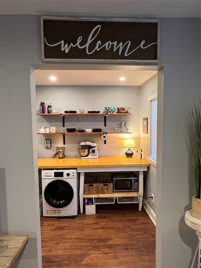 bar featuring dark hardwood / wood-style floors and washer / clothes dryer