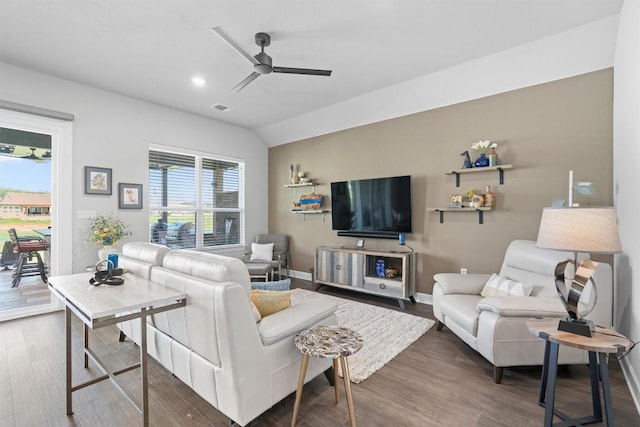 living room with ceiling fan, dark wood-type flooring, and vaulted ceiling