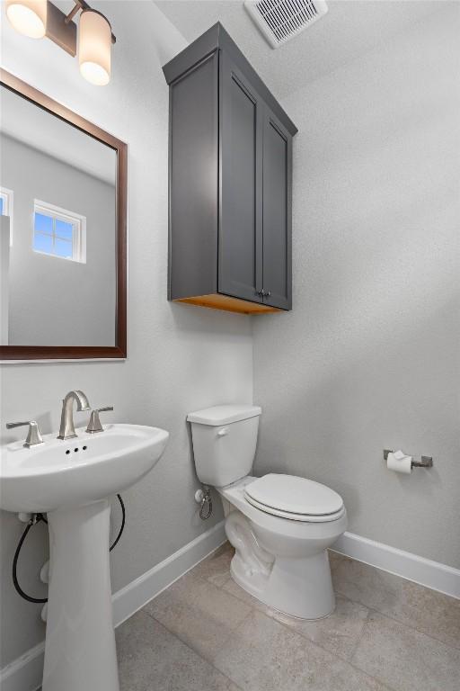 bathroom with sink, tile patterned flooring, and toilet