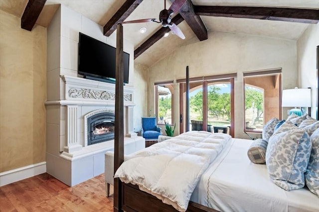 bedroom featuring lofted ceiling with beams, ceiling fan, and hardwood / wood-style flooring