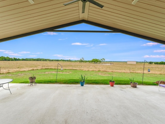 view of patio / terrace with ceiling fan and a rural view