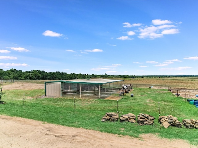 view of yard with an outbuilding and a rural view