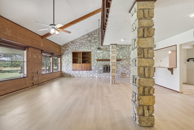 unfurnished living room with high vaulted ceiling, a textured ceiling, ceiling fan, and light wood-type flooring