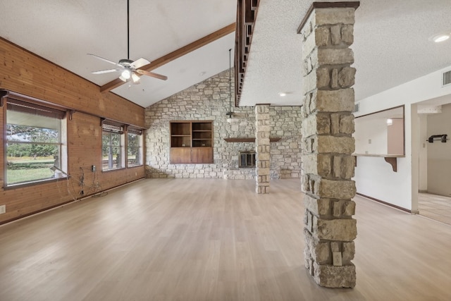 unfurnished living room featuring a textured ceiling, hardwood / wood-style flooring, high vaulted ceiling, and ceiling fan