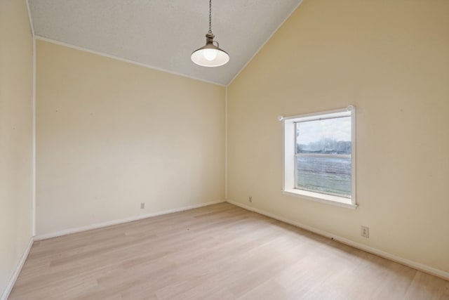 unfurnished room featuring light hardwood / wood-style flooring and high vaulted ceiling