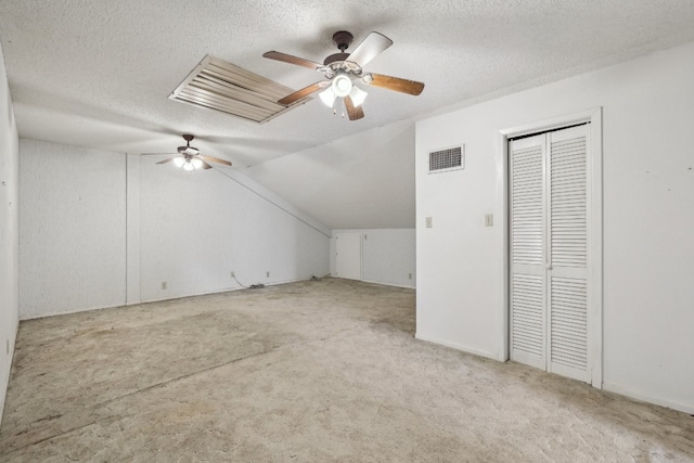 additional living space featuring a textured ceiling, ceiling fan, and lofted ceiling