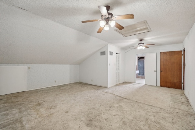 bonus room featuring ceiling fan, lofted ceiling, carpet, and a textured ceiling