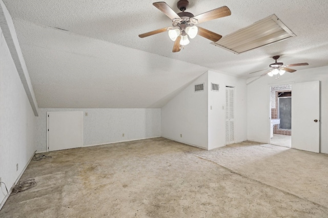 bonus room featuring carpet floors, a textured ceiling, and ceiling fan